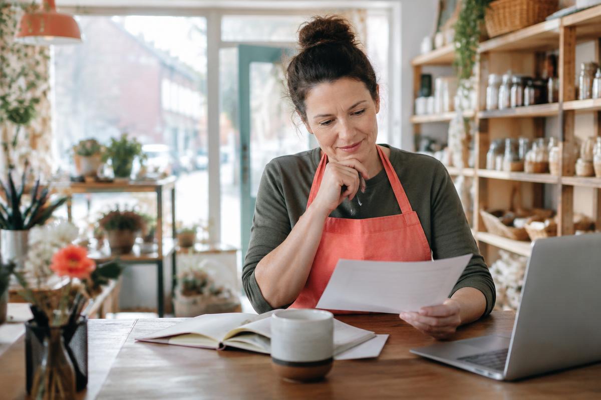 Shop owner reviewing a business credit recovery plan
